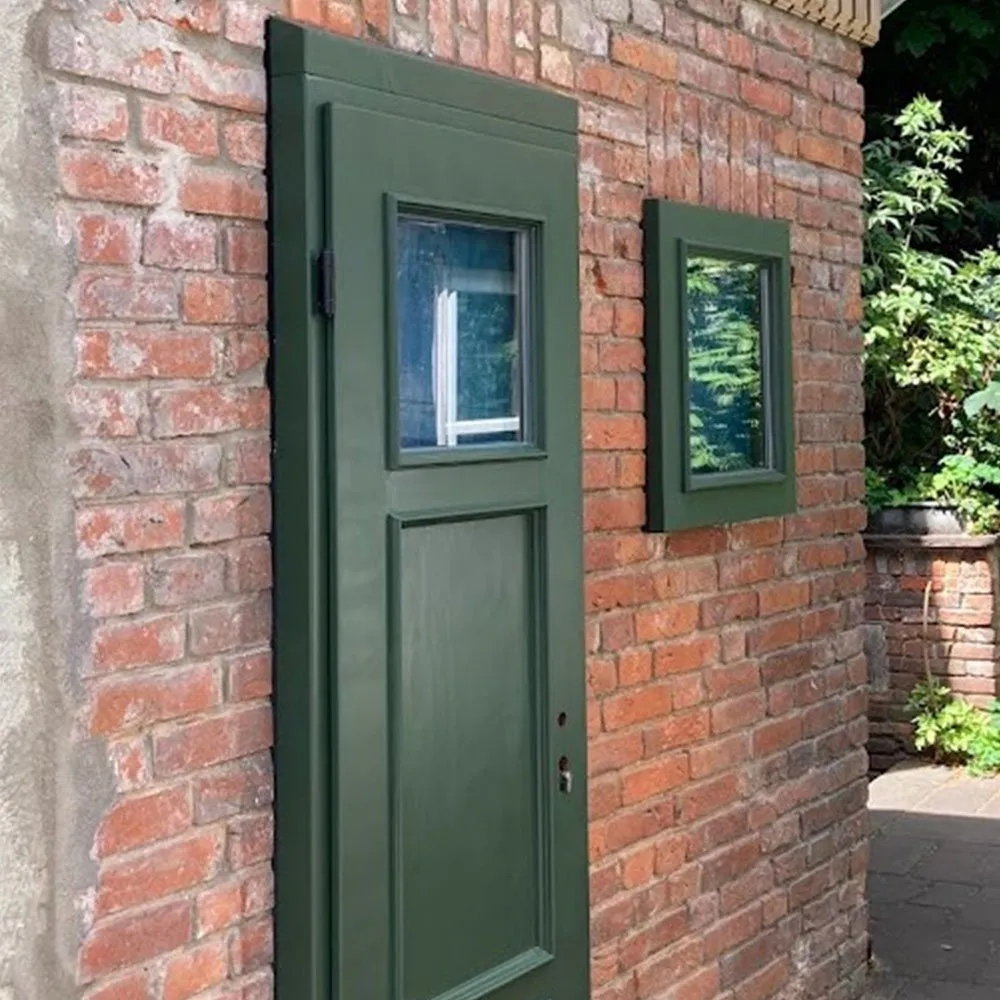Kleinstes Haus Deutschlands im Bremer Schnoor: Backsteinfassade mit grüner Tür und grünen Fensterrahmen