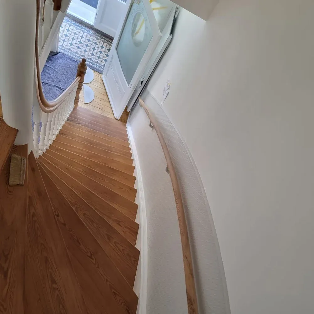 Gewendelte Holztreppe von oben vor der Sanierung mit dunkler, verschlissener Oberfläche