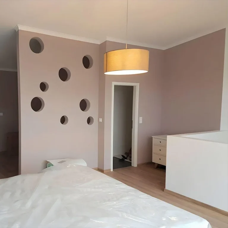 Schlafzimmer mit Trockenbauwand mit runden Ausschnitten, abgestimmten Wandfarben und Parkettboden